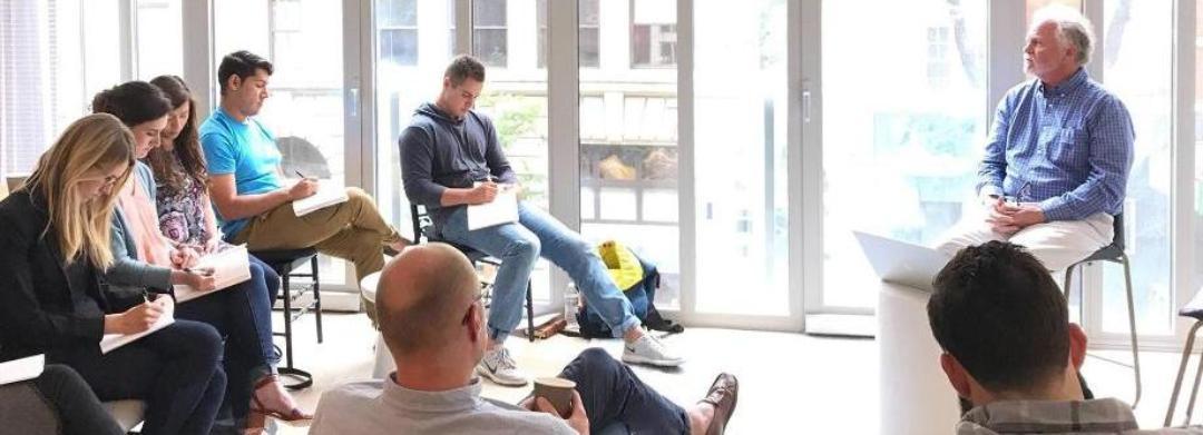 Small Group of People Listening to a Speaker