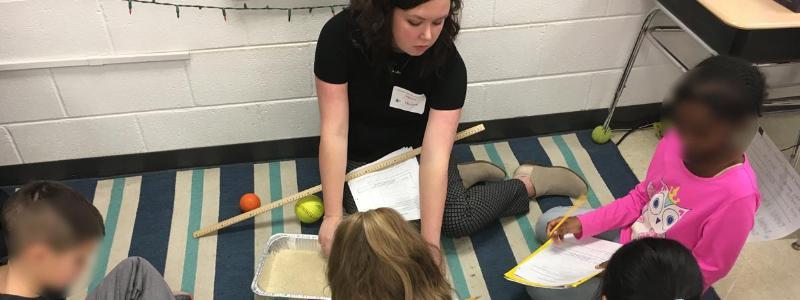 teacher on the floor with students