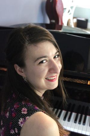 A graduate student sitting at the piano