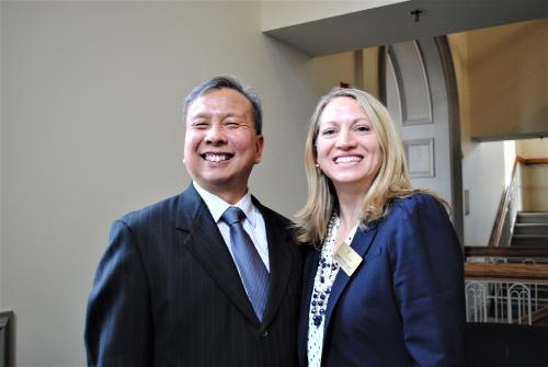 two professors smiling at a conference