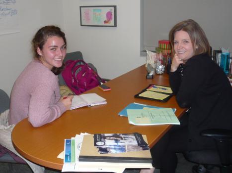 Director sitting at desk advising female student