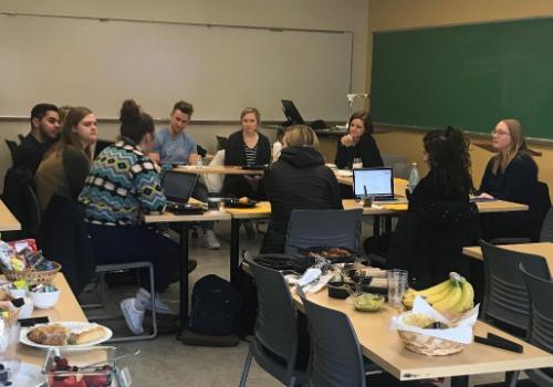 Students discussing around table