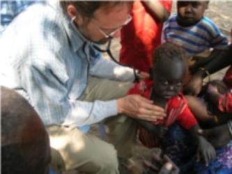 doctor squatting treating child