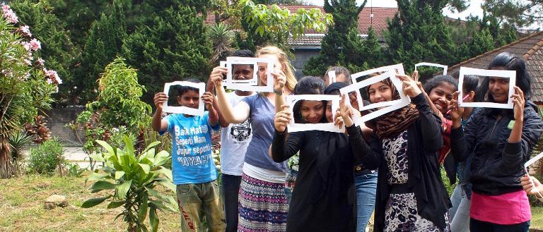 HNGR student with children and signs