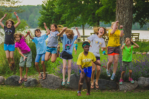 A group of children jumping and smiling