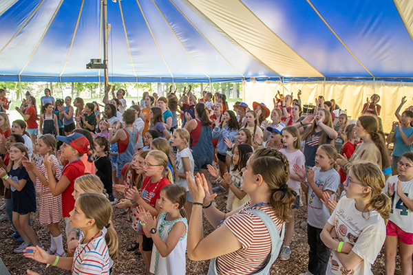 A group of teenagers clapping and singing