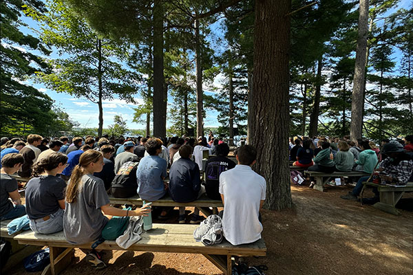 Students worshiping in the woods