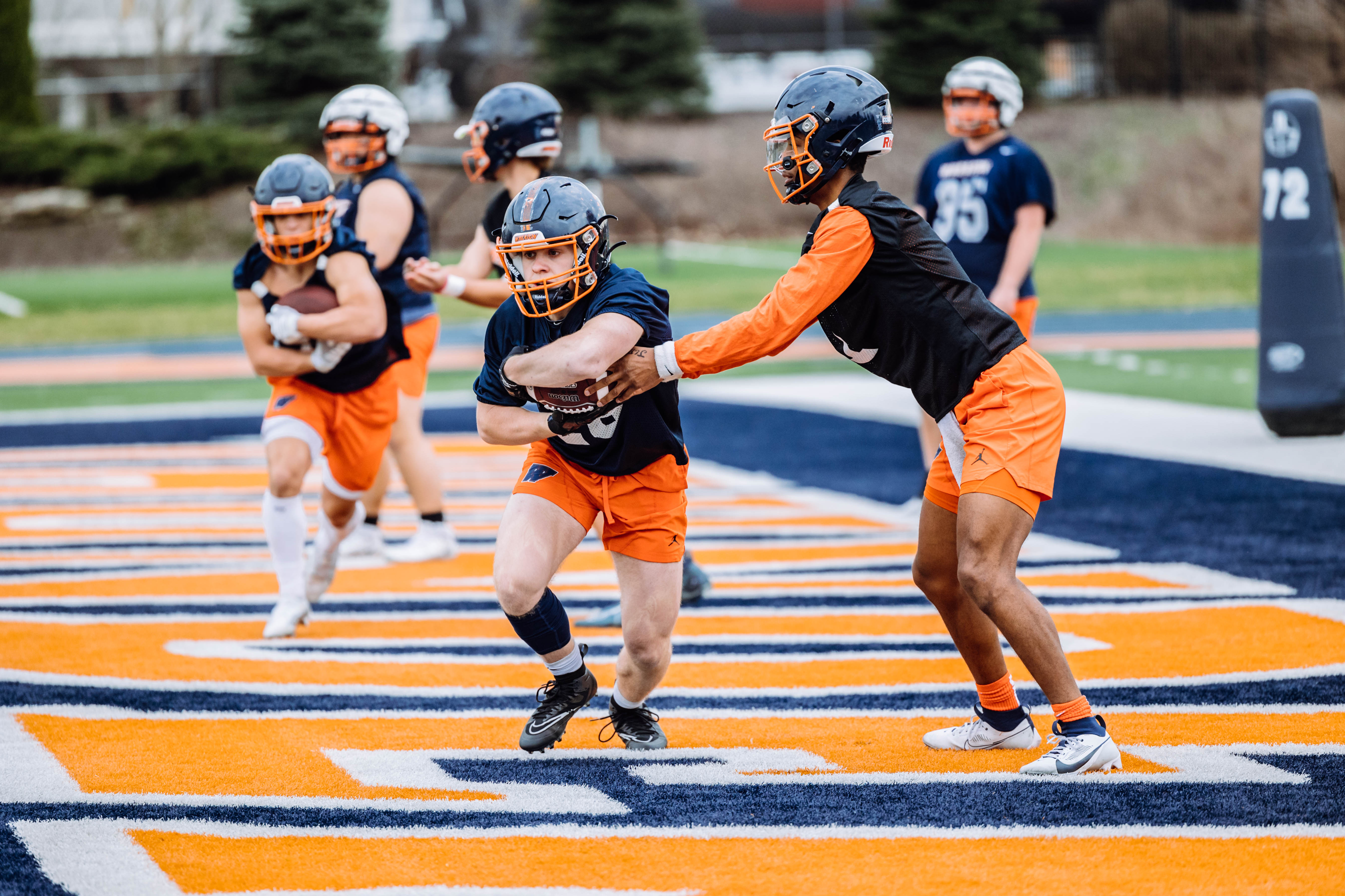 Wheaton College Football athletes during practice