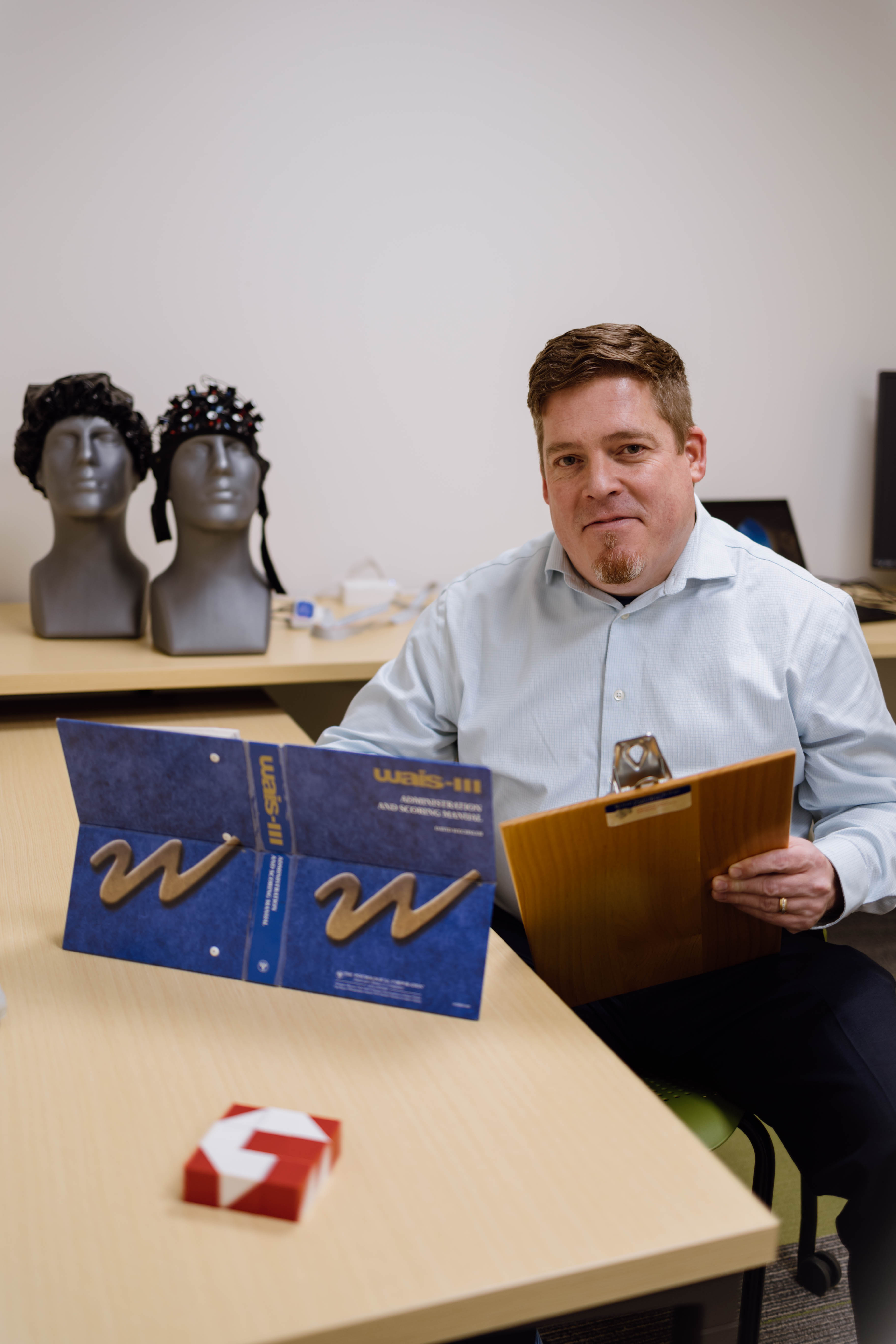 Wheaton College IL Dr. Ben Pyykkonen with infrared brain sensors used in the Neurocognitive Functioning Lab