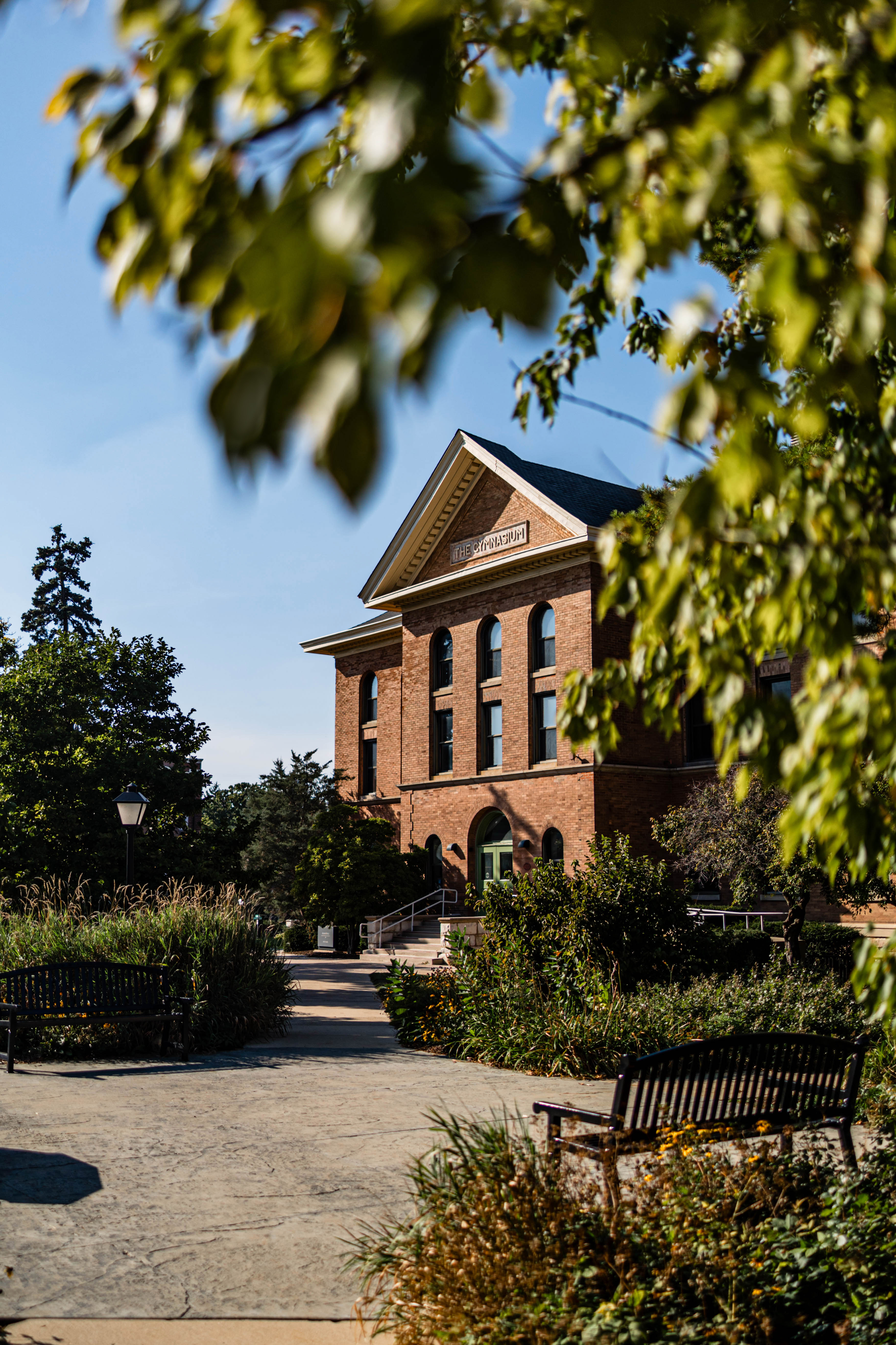 Old brick building surrounded by greenery