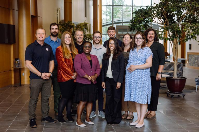 Eleven Wheaton College faculty stand in two rows