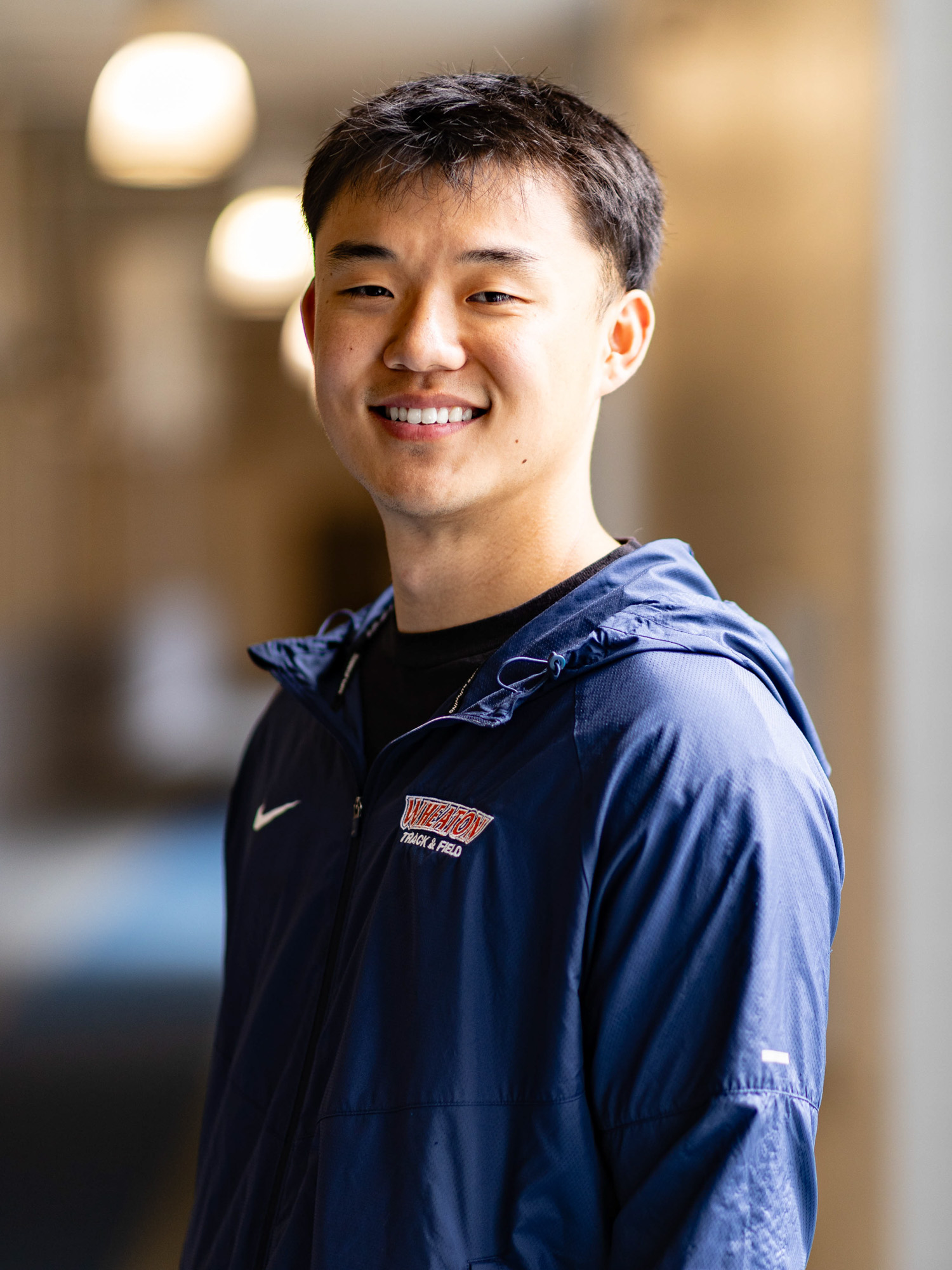 A young East Asian man smiles