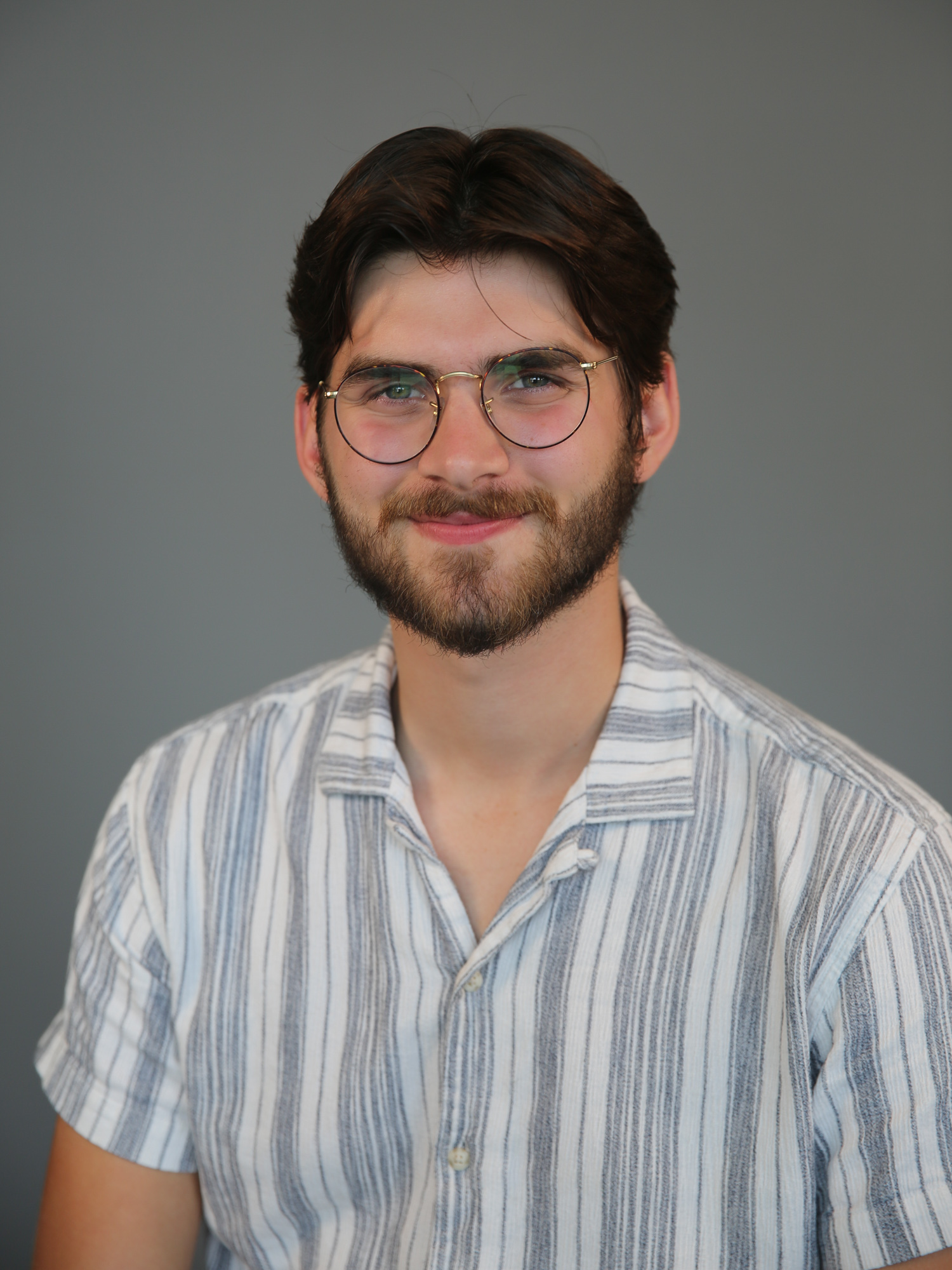 A young brunette white male smiles