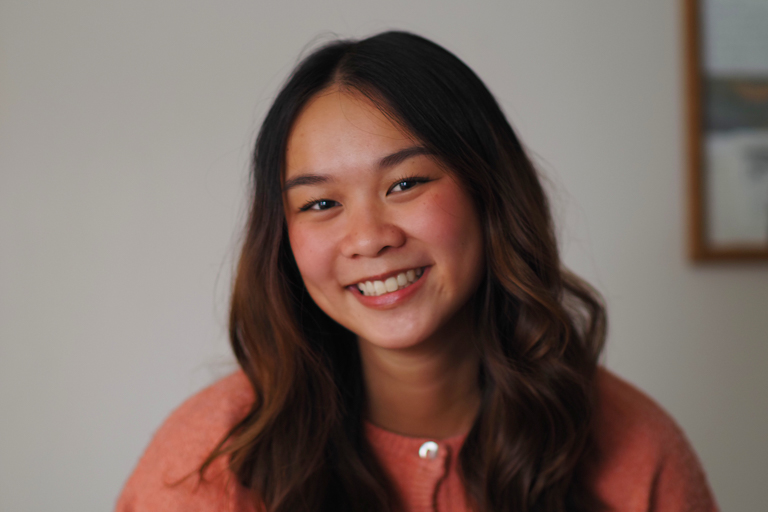 An East Asian young woman smiles