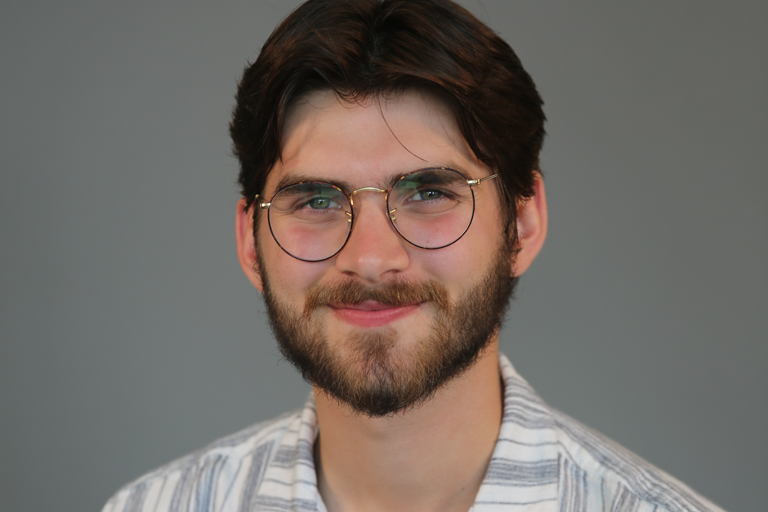 A young brunette white male smiles