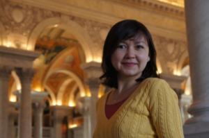 Jenya standing inside a church and smiling at the camera