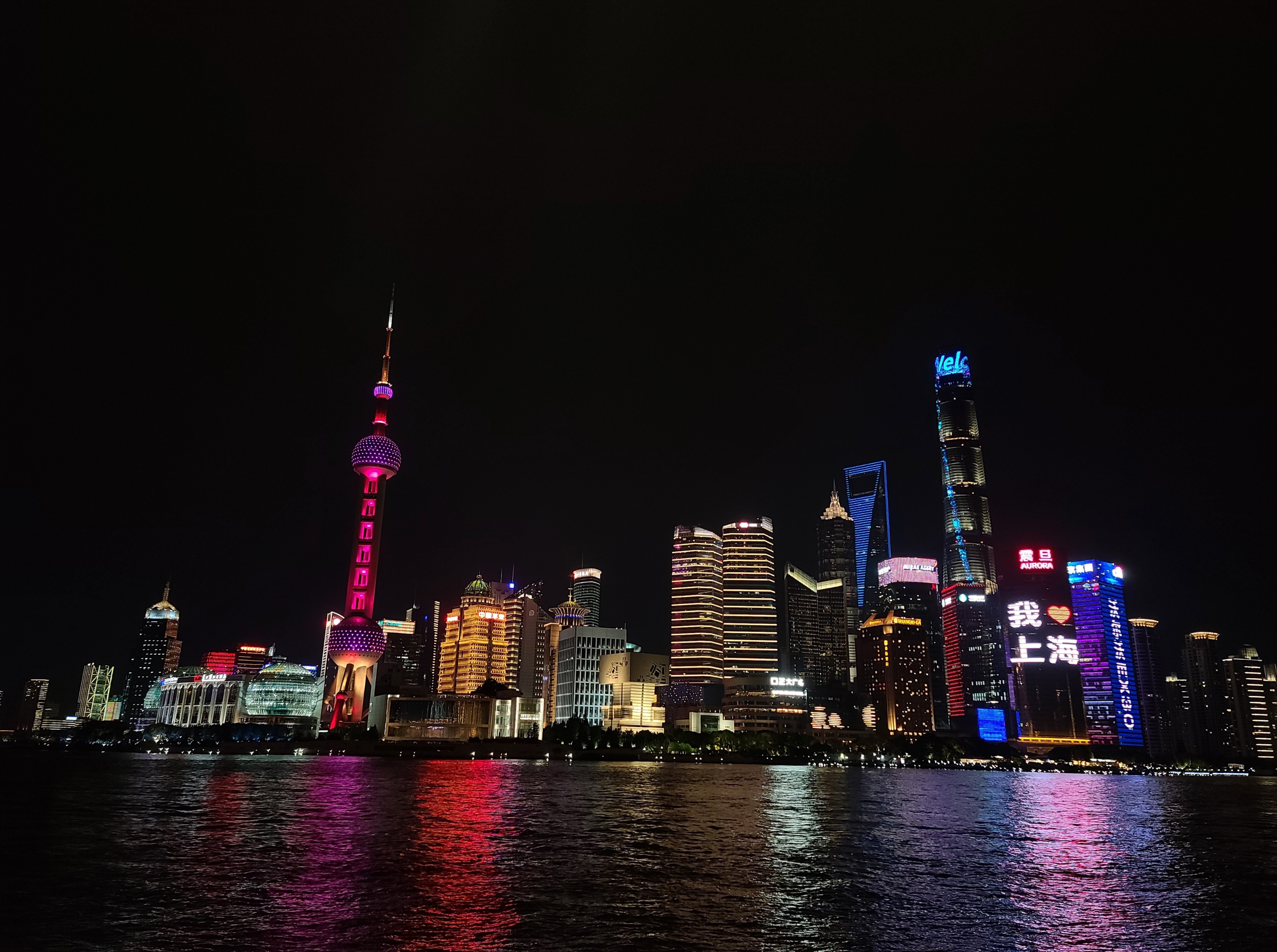 Photograph of view of Shanghai at night from the water