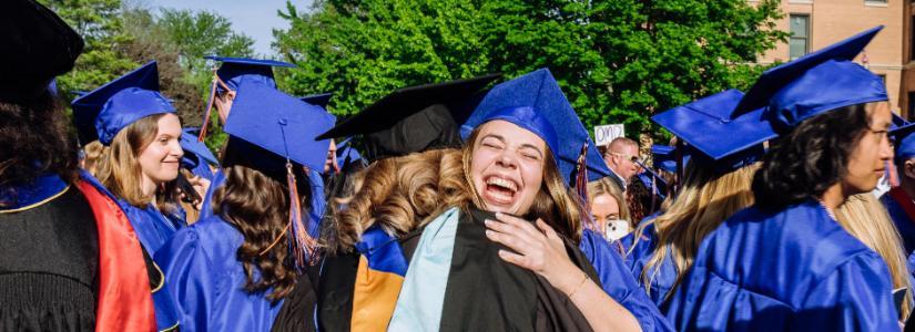 Commencement 2024 hugging friends 825 x 300