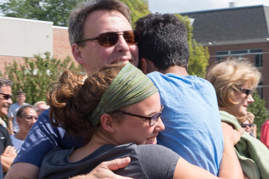 Parents hugging their student