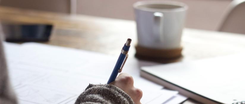 Writing with coffee cup in background  825 x 350