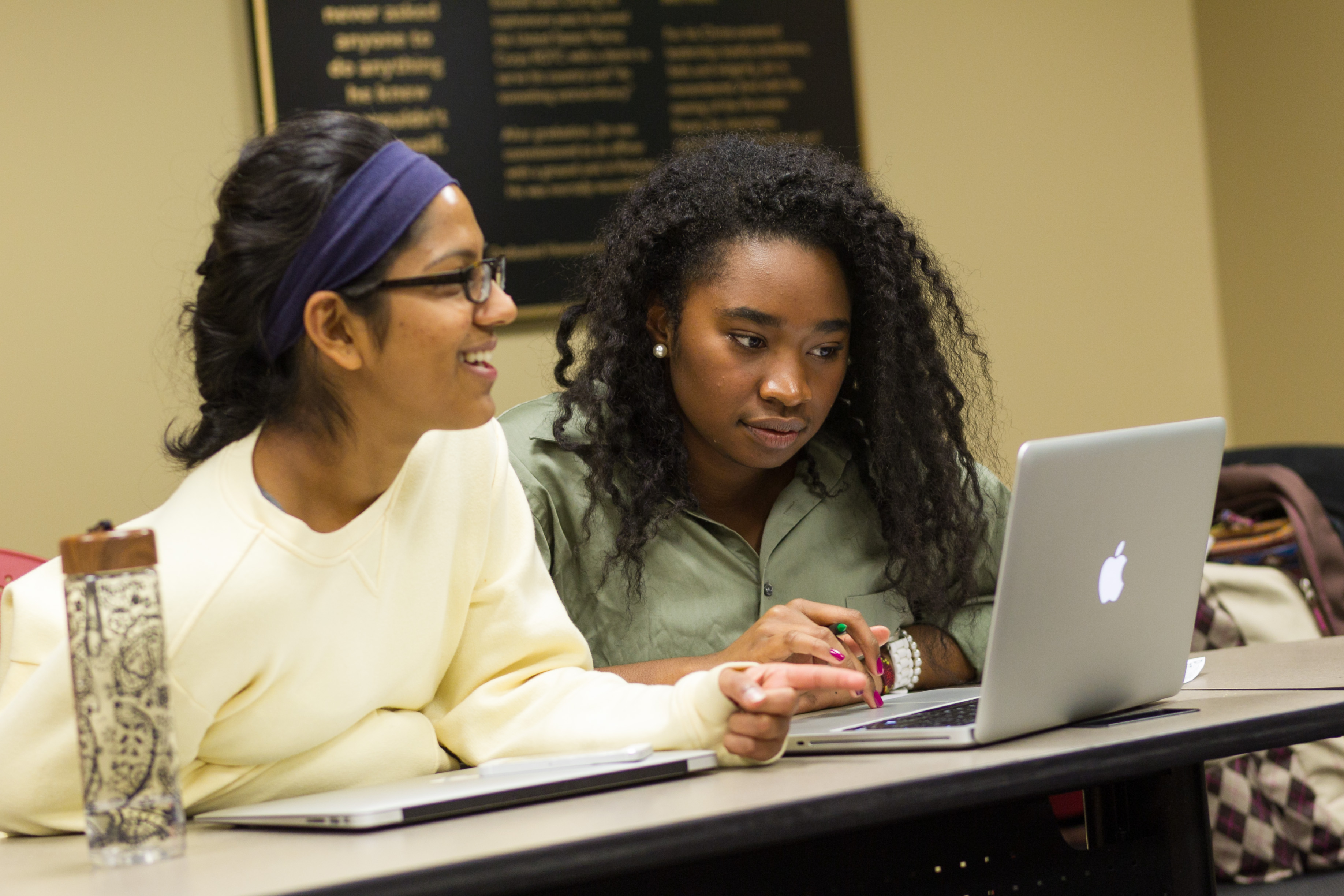 Two students at computer in classroom